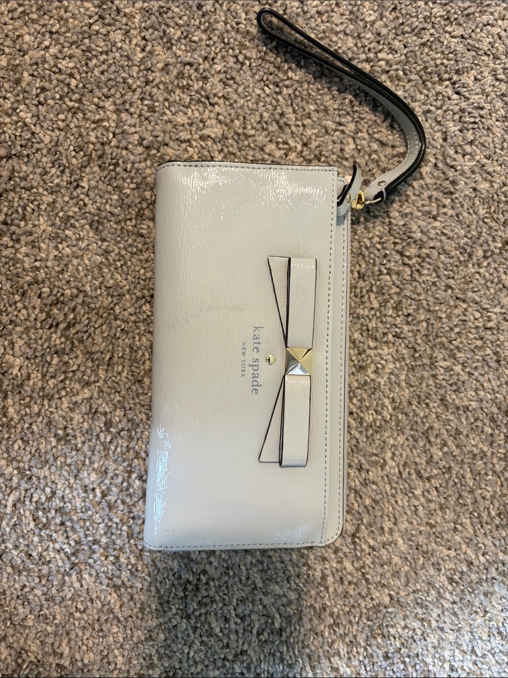 kate spade Cream Patent Leather Wristlet with Bow and Gold Accent